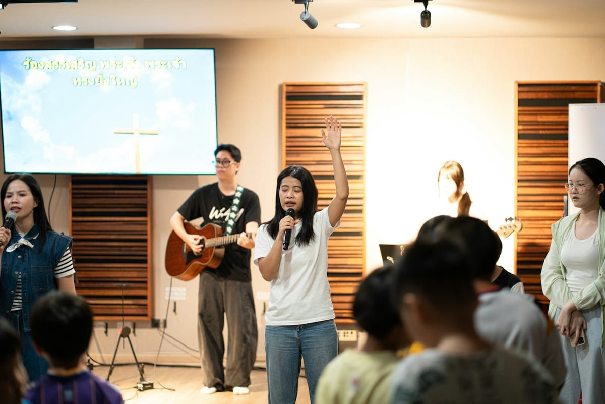 A worship team leading a small congregation in song